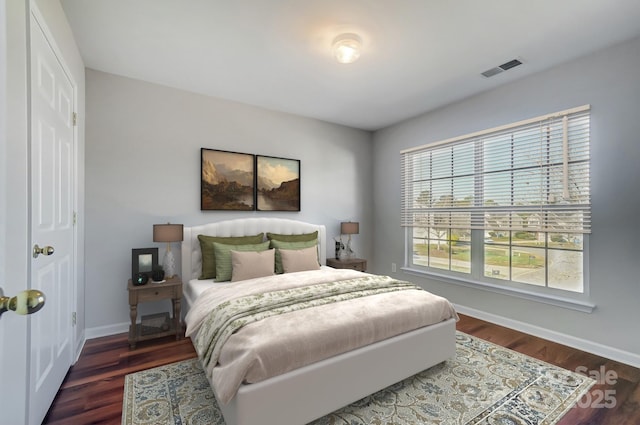 bedroom with dark hardwood / wood-style floors