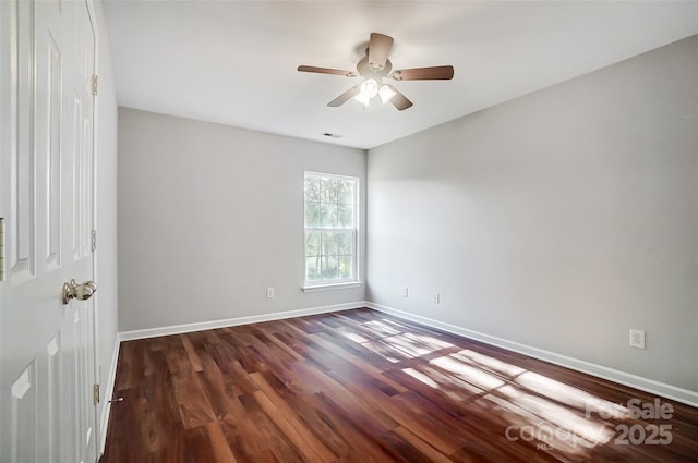 empty room with ceiling fan and dark hardwood / wood-style floors