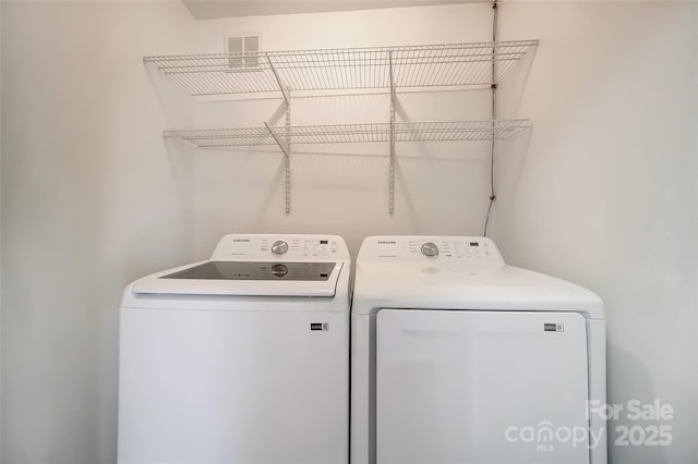 washroom featuring independent washer and dryer