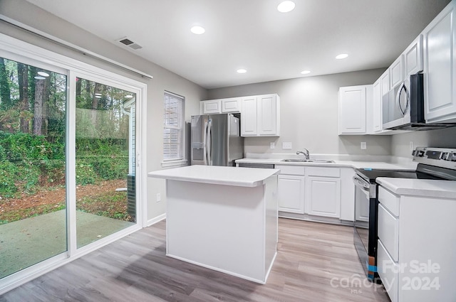 kitchen with a center island, white cabinetry, sink, and appliances with stainless steel finishes