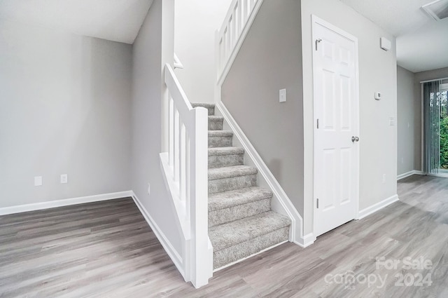 stairs featuring wood-type flooring