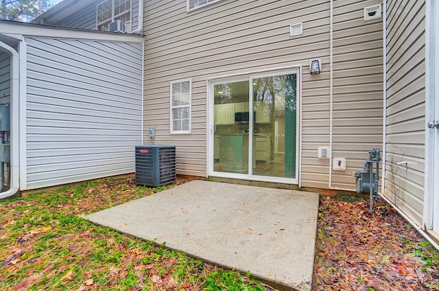 doorway to property with a patio area and central AC