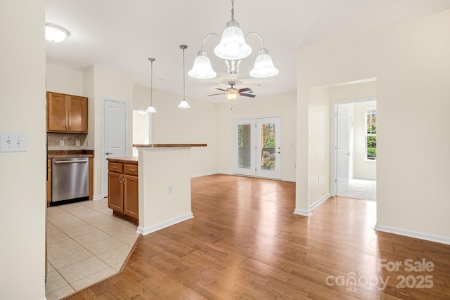 kitchen with decorative backsplash, ceiling fan with notable chandelier, decorative light fixtures, and stainless steel dishwasher