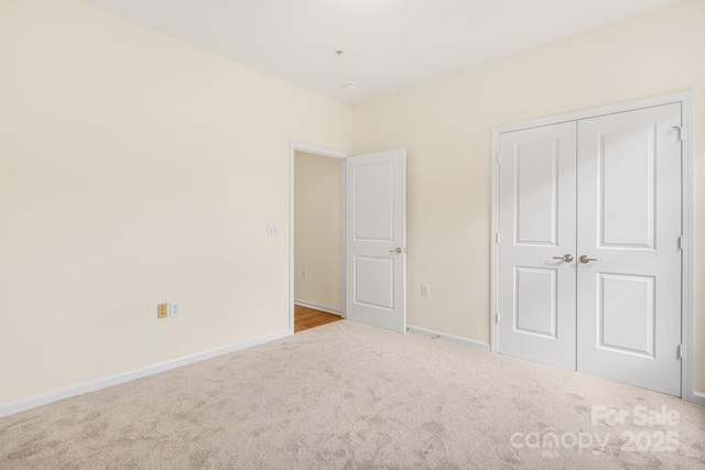 unfurnished bedroom featuring carpet flooring and a closet