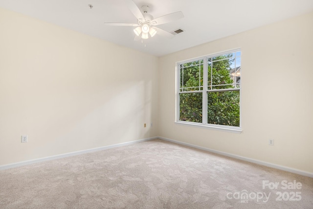 spare room featuring carpet flooring and ceiling fan