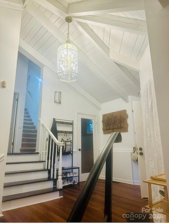 stairs featuring wooden ceiling, an inviting chandelier, wood-type flooring, and vaulted ceiling with beams