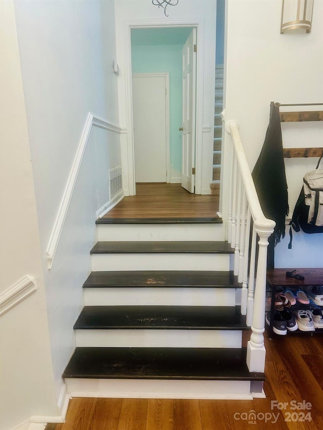 stairway featuring hardwood / wood-style flooring