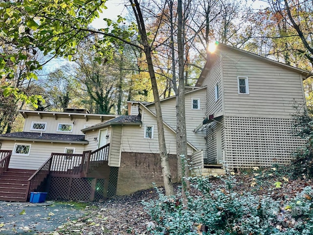 rear view of property with a wooden deck