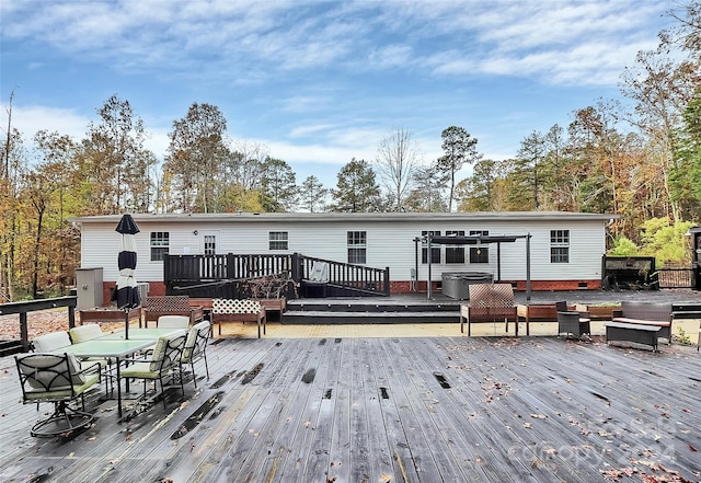 back of property featuring a deck