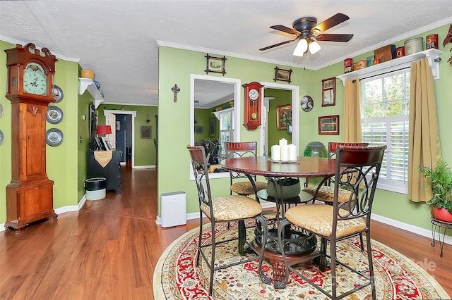 dining area with ornamental molding, hardwood / wood-style floors, a textured ceiling, and ceiling fan