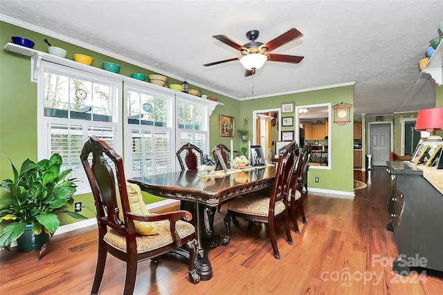 dining area with ceiling fan, a textured ceiling, dark hardwood / wood-style floors, and crown molding