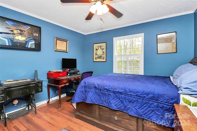 bedroom with hardwood / wood-style floors, ceiling fan, and ornamental molding