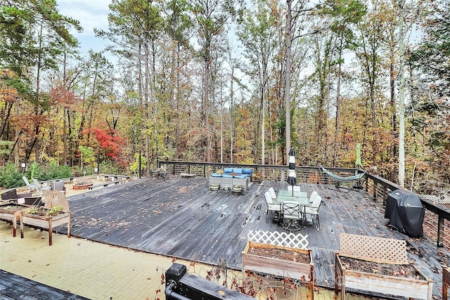 2164 Mission Rd, York, SC 29745 - deck featuring outdoor dining area, a forest view, area for grilling, and a vegetable garden