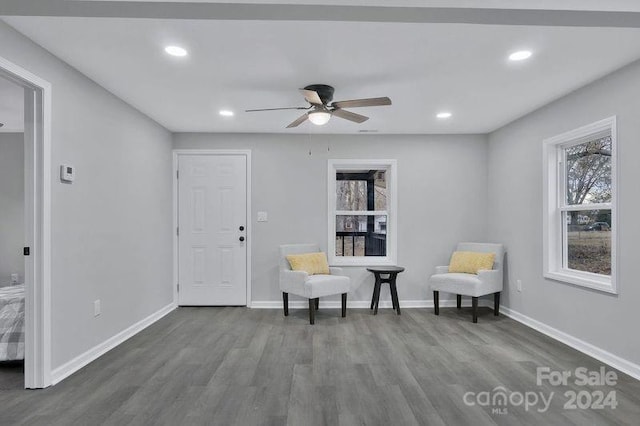 sitting room featuring ceiling fan and dark wood-type flooring