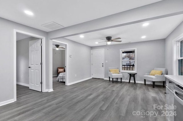 sitting room featuring dark hardwood / wood-style floors and ceiling fan