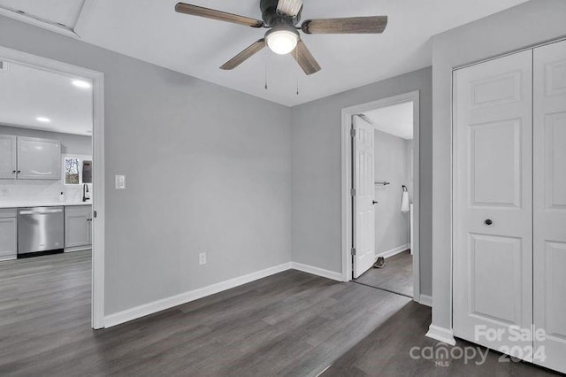 bedroom featuring a closet, ceiling fan, ensuite bathroom, and dark wood-type flooring