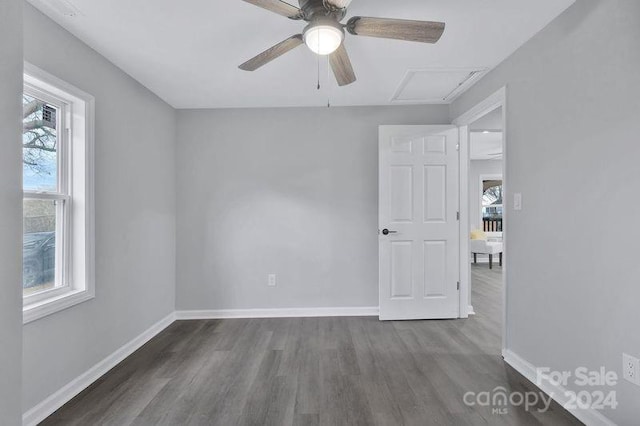 unfurnished room with ceiling fan and dark hardwood / wood-style flooring