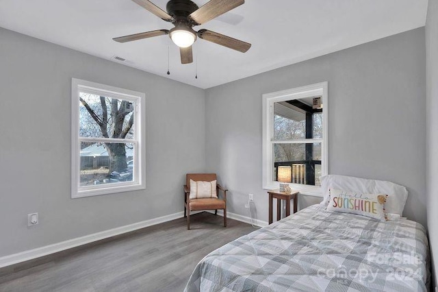 bedroom with wood-type flooring and ceiling fan