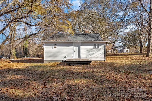 view of outbuilding featuring a lawn