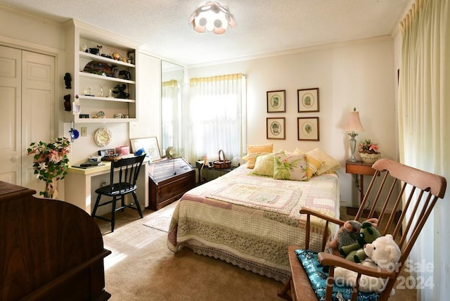 carpeted bedroom featuring a closet, a textured ceiling, and ornamental molding