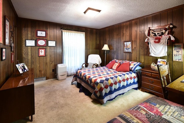 carpeted bedroom featuring wooden walls and a textured ceiling