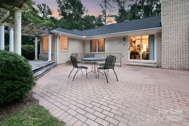 patio terrace at dusk with a pergola