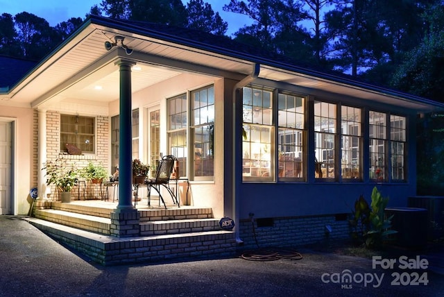 view of side of property with a porch