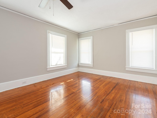 unfurnished room with hardwood / wood-style floors, ceiling fan, and ornamental molding