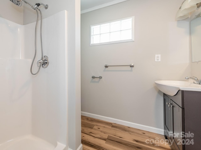 bathroom with vanity, wood-type flooring, and walk in shower