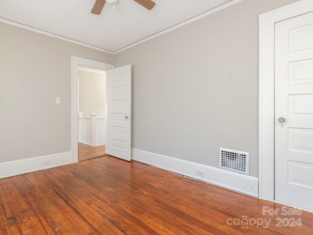 spare room with hardwood / wood-style floors, ceiling fan, and crown molding