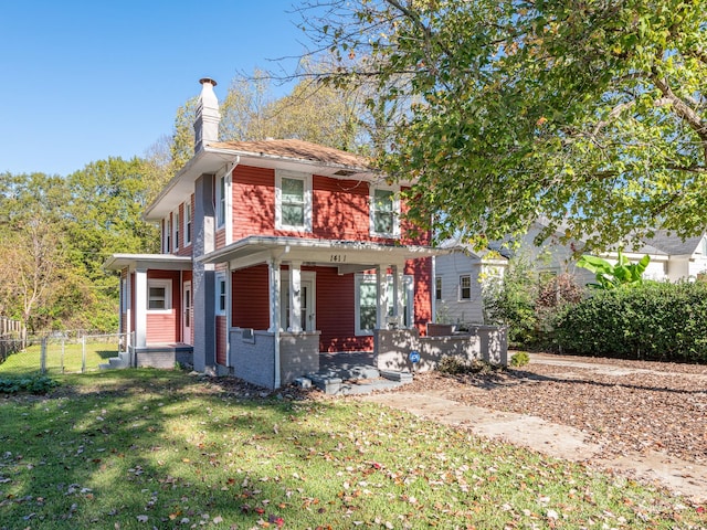 view of front of house with a porch and a front yard