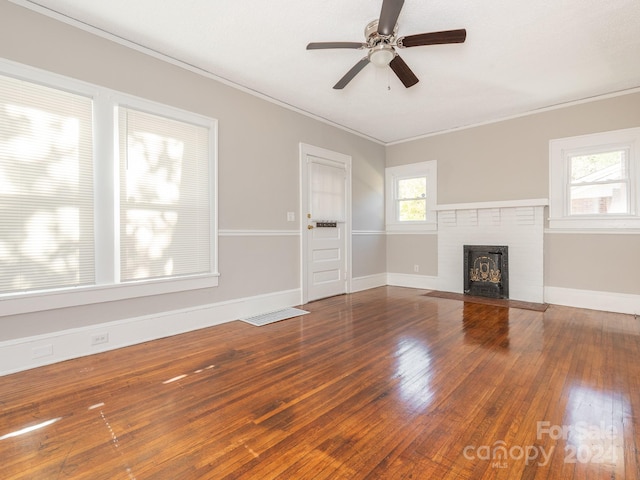 unfurnished living room featuring hardwood / wood-style floors, plenty of natural light, crown molding, and ceiling fan