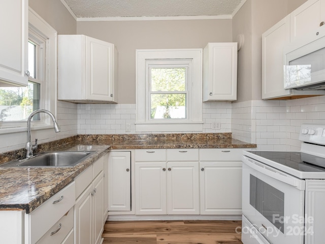 1411 Lineberger Ave, Gastonia, NC 28052 - kitchen featuring white appliances, a sink, plenty of natural light, white cabinetry, and ornamental molding