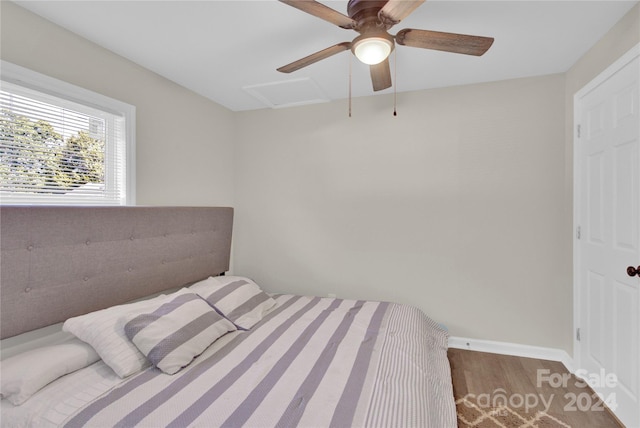 bedroom with ceiling fan and hardwood / wood-style flooring