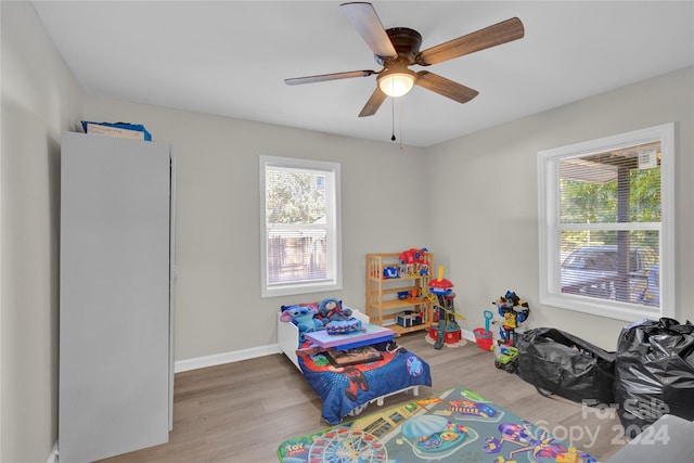 game room with light hardwood / wood-style flooring and ceiling fan