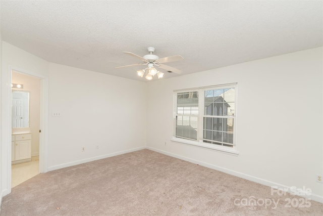 unfurnished room with light carpet, ceiling fan, and a textured ceiling