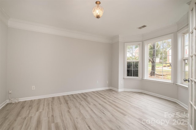 empty room featuring crown molding, light hardwood / wood-style flooring, and a healthy amount of sunlight