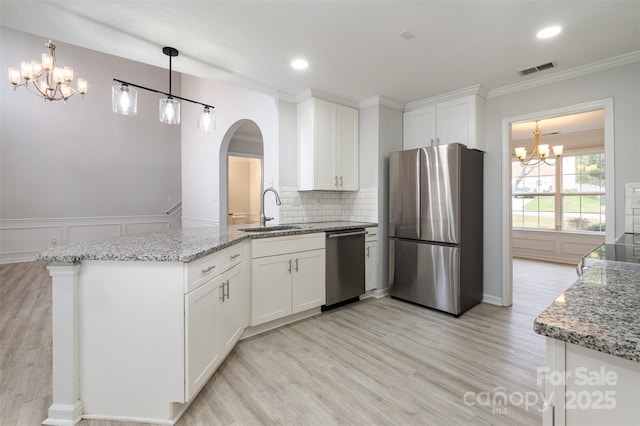 kitchen with white cabinetry, sink, stainless steel appliances, and light stone countertops