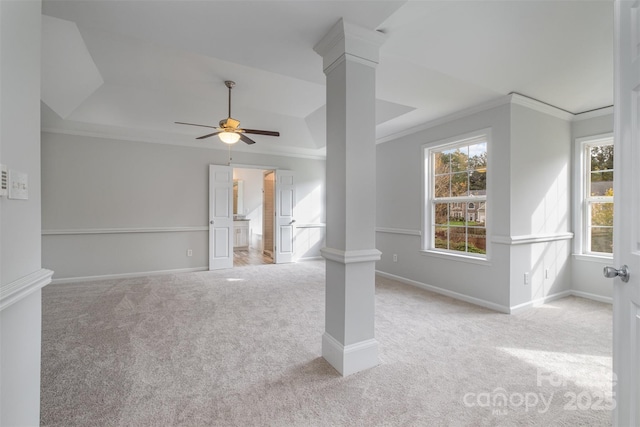 empty room featuring ceiling fan, ornamental molding, decorative columns, and light carpet