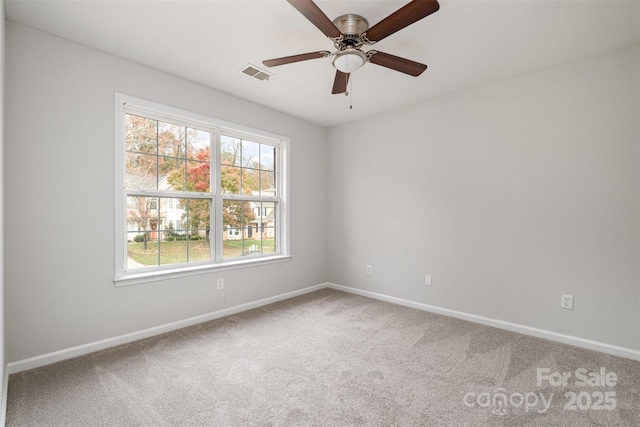 carpeted spare room with ceiling fan