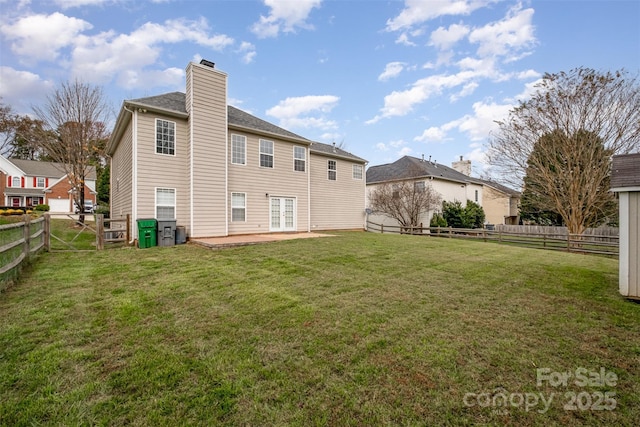 rear view of house with a yard