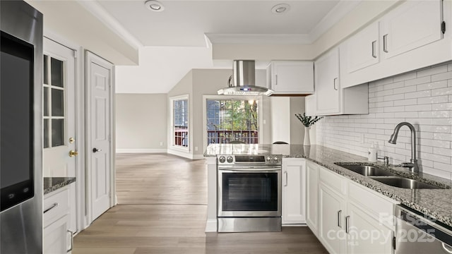 kitchen with sink, appliances with stainless steel finishes, white cabinetry, dark stone countertops, and range hood