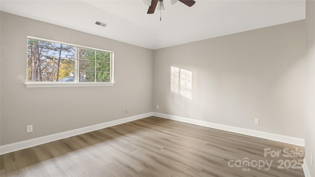 spare room featuring hardwood / wood-style flooring and ceiling fan