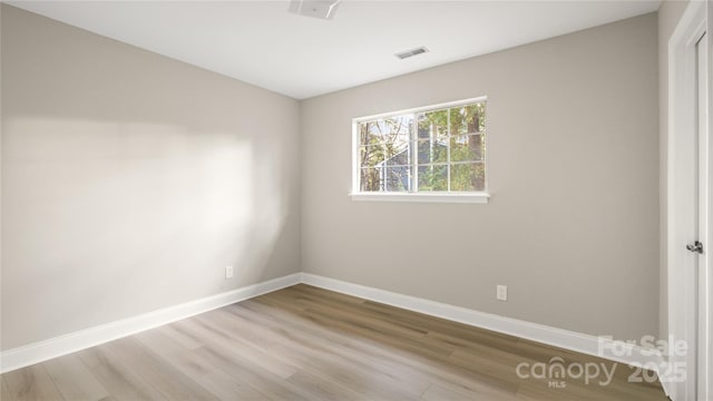 spare room featuring light hardwood / wood-style floors