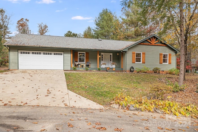 view of front of house featuring a front lawn, a garage, and covered porch