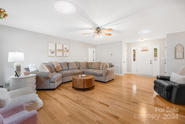 living room with ceiling fan and light hardwood / wood-style floors