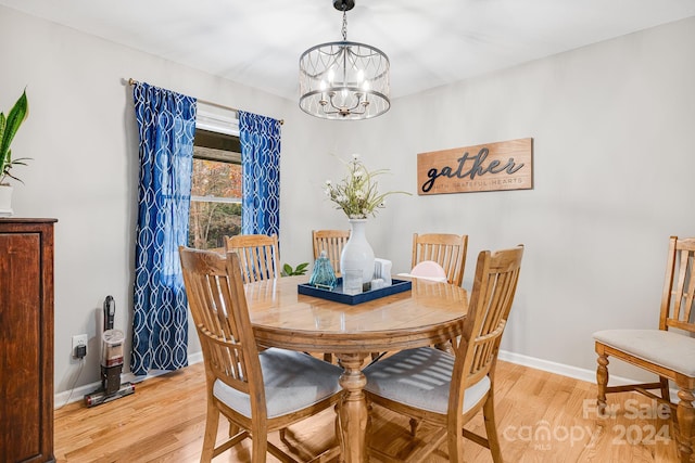 dining room featuring light hardwood / wood-style floors and a chandelier