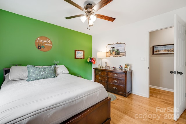 bedroom with ceiling fan and light hardwood / wood-style floors