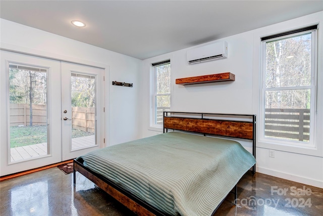 bedroom with access to outside, french doors, and a wall mounted AC