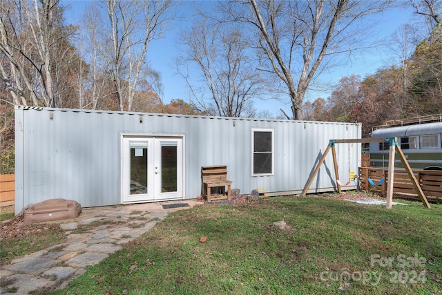 rear view of house featuring french doors and a yard